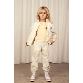 Mini Rodini pantaloni de trening pentru copii culoarea bej, cu imprimeu