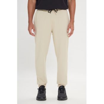 Pantaloni de trening uni cu buzunare laterale