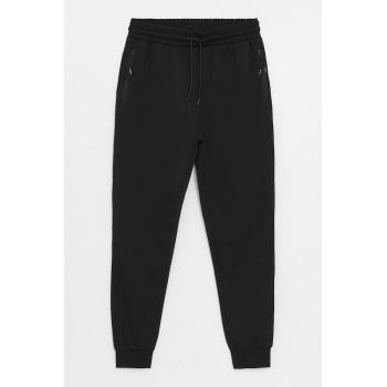 Pantaloni de trening conici cu buzunare cu fermoar