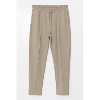 Pantaloni de trening cambrati cu snur de ajustare si model uni