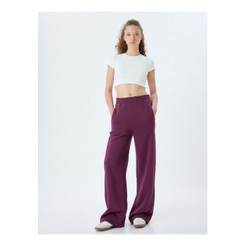 Pantaloni de trening cu croiala ampla si model uni