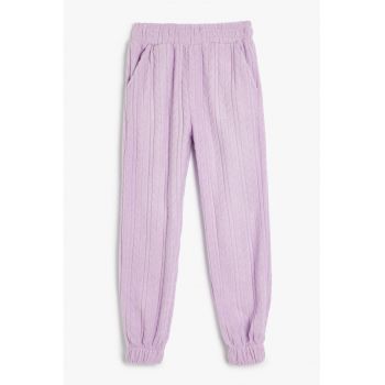 Pantaloni de trening cu croiala conica si aspect texturat